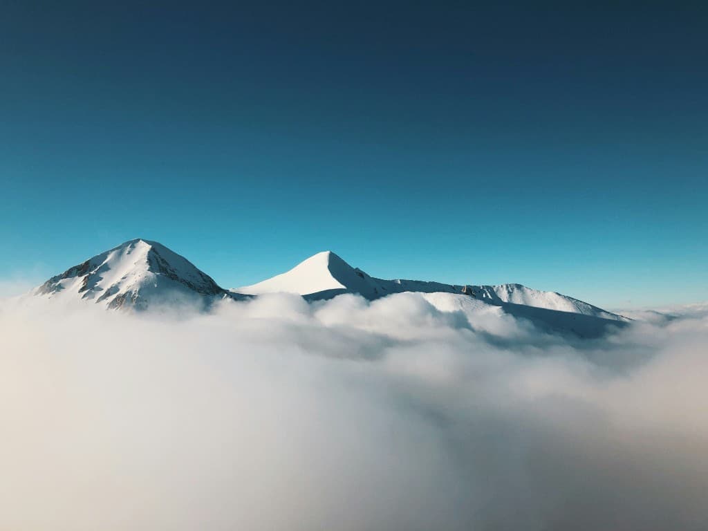 Mountain peaks emerging through clouds